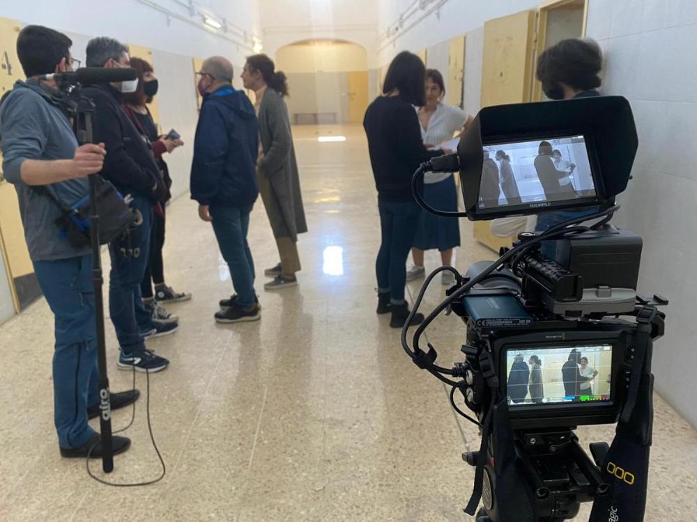  actors i actrius amb l'equip tècnic abans de rodar una escena, dins de la pressó.